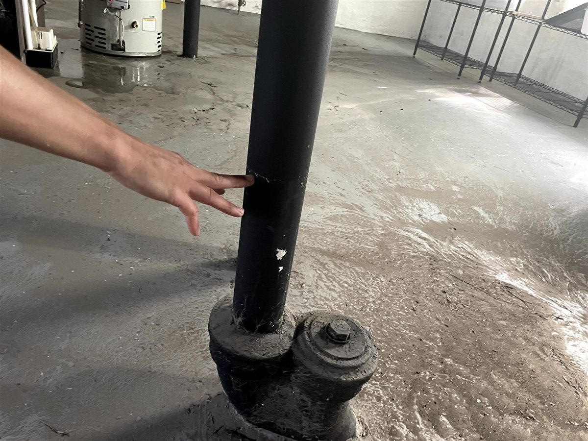 Emergency basement plumbing repair with wet floor
